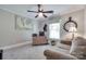 Home office featuring carpeted floors, a ceiling fan, and a large window at 12311 Bentcreek Ln, Matthews, NC 28105