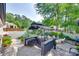 A paved outdoor patio features a covered grill, a bar, and comfortable seating surrounded by lush landscaping at 12311 Bentcreek Ln, Matthews, NC 28105