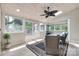 Bright sunroom with tile floors, skylights, a ceiling fan, and large windows overlooking the yard at 12311 Bentcreek Ln, Matthews, NC 28105
