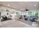 Expansive sunroom featuring tile floors, multiple ceiling fans, and beautiful outdoor views at 12311 Bentcreek Ln, Matthews, NC 28105