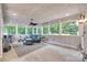Spacious sunroom with tile floors, ceiling fans, and large windows providing natural light at 12311 Bentcreek Ln, Matthews, NC 28105