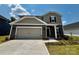 Charming two-story home features a two-car garage and landscaped front yard at 1423 Windy Park Dr, Stanley, NC 28164