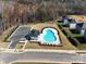 Aerial view of community pool with parking and green space near residences at 1423 Windy Park Dr, Stanley, NC 28164