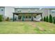 Spacious backyard with a covered patio, hammock, privacy fence, and green lawn at 150 Haddonsfield Dr, Mooresville, NC 28115