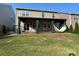 Enjoy this backyard with a covered patio, outdoor curtains, ceiling fan and hammock at 150 Haddonsfield Dr, Mooresville, NC 28115