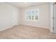 Bedroom featuring a double door closet, carpet, and natural light from the shuttered window at 150 Haddonsfield Dr, Mooresville, NC 28115