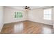 This bedroom is spacious and features wood floors and a window with white shutters at 150 Haddonsfield Dr, Mooresville, NC 28115