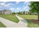 Beautiful neighborhood with walking path, green space and manicured lawns under a bright blue sky at 150 Haddonsfield Dr, Mooresville, NC 28115