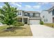 Charming two-story home with a well-manicured lawn and two-car garage at 150 Haddonsfield Dr, Mooresville, NC 28115