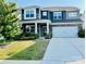 Charming two-story home with stone accents, a well-manicured lawn and an attached two-car garage at 150 Haddonsfield Dr, Mooresville, NC 28115