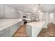 Modern kitchen with an oversized island, stainless steel appliances, and chandelier lighting at 150 Haddonsfield Dr, Mooresville, NC 28115