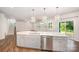 Kitchen island has modern cabinetry, stainless steel dishwasher and sink, and quartz countertop at 150 Haddonsfield Dr, Mooresville, NC 28115