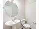 Half bath features a pedestal sink and decorative mirror at 150 Haddonsfield Dr, Mooresville, NC 28115
