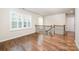 Upstairs landing area with wood floors, window with shutters, and wrought iron railing at 150 Haddonsfield Dr, Mooresville, NC 28115