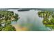 Expansive lake view showcasing waterfront properties surrounded by lush, mature trees on a sunny day at 150 Pinnacle Shores Dr, Mooresville, NC 28117