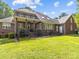 Expansive brick home featuring a covered porch and an open, grassy backyard perfect for outdoor enjoyment at 150 Pinnacle Shores Dr, Mooresville, NC 28117