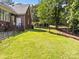 A lush, green backyard featuring well-maintained grass and a border of trees on a sunny day at 150 Pinnacle Shores Dr, Mooresville, NC 28117