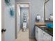 Stylish bathroom featuring a toilet room beyond an arched doorway and a vanity with a striking blue decorative bowl at 150 Pinnacle Shores Dr, Mooresville, NC 28117