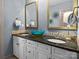 Bathroom featuring double sinks, granite countertops and gold fixtures and trim, along with blue accent pieces at 150 Pinnacle Shores Dr, Mooresville, NC 28117