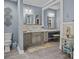 Elegant bathroom boasts double vanity, tiled floors and walls, toilet and a doorway into another bathroom section at 150 Pinnacle Shores Dr, Mooresville, NC 28117