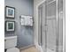 Bathroom with a toilet, towel rack, and a glass shower enclosure with gold framed prints at 150 Pinnacle Shores Dr, Mooresville, NC 28117