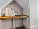 Cozy desk nook with a dark stained wood countertop and grey paneling at 150 Pinnacle Shores Dr, Mooresville, NC 28117