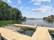 Scenic view of a private boat dock with boat lifts and watercraft on a tranquil lake at 150 Pinnacle Shores Dr, Mooresville, NC 28117