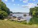 Picturesque lake scene featuring multiple docks and a variety of boats under a bright sky at 150 Pinnacle Shores Dr, Mooresville, NC 28117