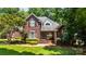 Beautiful brick two-story home with landscaped lawn and manicured shrubs on a sunny day at 150 Pinnacle Shores Dr, Mooresville, NC 28117