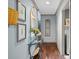Inviting hallway features stylish decor, hardwood floors, and access to the laundry room at 150 Pinnacle Shores Dr, Mooresville, NC 28117