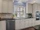 Bright kitchen features stainless steel appliances, granite countertops, and custom cabinetry at 150 Pinnacle Shores Dr, Mooresville, NC 28117