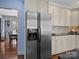 Modern kitchen with stainless steel refrigerator, white cabinets, and granite countertops at 150 Pinnacle Shores Dr, Mooresville, NC 28117