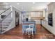 Open kitchen with an island and stainless steel appliances adjacent to staircase at 150 Pinnacle Shores Dr, Mooresville, NC 28117