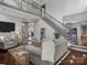 Spacious living room with hardwood floors, staircase, and an open layout to the kitchen at 150 Pinnacle Shores Dr, Mooresville, NC 28117
