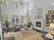 Bright living room with high ceilings, large windows, fireplace, and comfortable seating at 150 Pinnacle Shores Dr, Mooresville, NC 28117