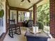 Covered brick porch with rocking chairs overlooking lush greenery at 150 Pinnacle Shores Dr, Mooresville, NC 28117