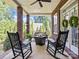 Inviting brick porch featuring rocking chairs and an outdoor sitting area at 150 Pinnacle Shores Dr, Mooresville, NC 28117