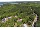 Aerial view of a luxury home nestled in a lush, green, wooded neighborhood at 16518 Here At Last Ln, Charlotte, NC 28278