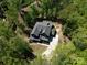 Stunning aerial view of a modern home surrounded by lush green trees at 16518 Here At Last Ln, Charlotte, NC 28278