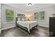 Cozy bedroom with hardwood floors, natural light from two windows and sports themed art work at 16518 Here At Last Ln, Charlotte, NC 28278