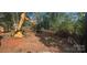 View of a lot being cleared with a construction vehicle and felled trees at 1676 Parkside Dr, Catawba, NC 28609