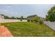 Spacious backyard with a well-manicured lawn and white fence, offering privacy at 1709 White Willow Ave, Gastonia, NC 28054