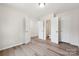 Spacious bedroom with wood-look flooring and multiple doorways, offering ample closet space at 1709 White Willow Ave, Gastonia, NC 28054