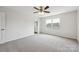 Bright, carpeted bedroom features a ceiling fan, large window, and ensuite bathroom at 1709 White Willow Ave, Gastonia, NC 28054