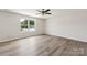 Bright bedroom with wood-look flooring and large window, creating a comfortable living space at 1709 White Willow Ave, Gastonia, NC 28054