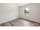 Comfortable bedroom features wood-look flooring and natural light from a large window at 1709 White Willow Ave, Gastonia, NC 28054