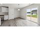 Bright dining area with laminate floors, sliding glass door, and views of the backyard at 1709 White Willow Ave, Gastonia, NC 28054