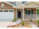 Charming front entrance featuring stone accents, decorative flower beds, and a well-lit porch at 1709 White Willow Ave, Gastonia, NC 28054
