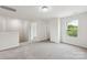 Upstairs loft space with neutral carpeting, a window, and two doorways, offering versatile living options at 1709 White Willow Ave, Gastonia, NC 28054
