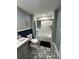 Updated bathroom featuring decorative tile floor and tub-shower with sliding glass enclosure at 200 Prospect Church Rd, Albemarle, NC 28001
